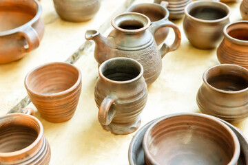 handmade beer mug made of clay and a bowl traditional european dishes stands on a wooden table