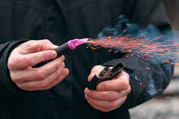 The Firecracker in a Hand. Man Holding a Burning Petard in His Hand. A Human with a Pyrotechnics...