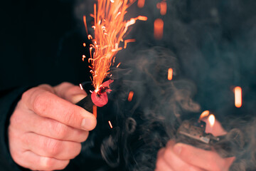 The Firecracker in a Hand. Man Holding a Burning Petard in His Hand. A Human with a Pyrotechnics...