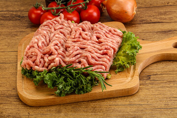 Raw pork minced meat over board