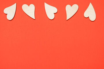 Valentine's day, love, romantic concept. Wooden hearts on a red background. Copy space