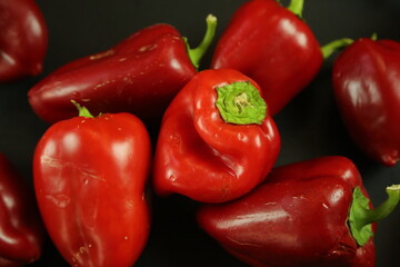 Red peppers on black background