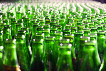 Blurry neck of green bottles