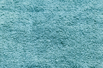 Fototapeta na wymiar abstract background of turquoise terry towel close up