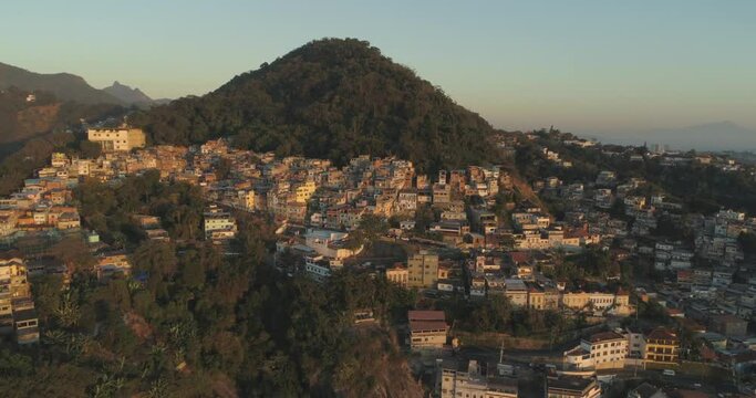 Rio de Janeiro mountain-top favela aerial at sunrise moving from Tavares Bastos towards Santo Amaro and town centre