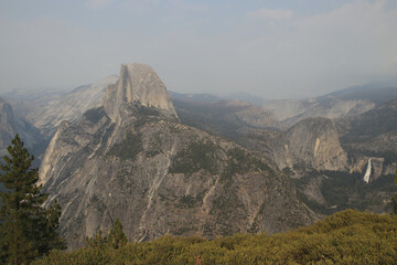 view in Yosemite National park with Half Dome small tree grass waterfall