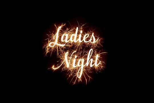 Cursive word of 'Ladies Night' in dazzling sparkler effect on dark background