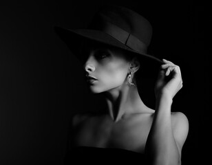 Beautiful makeup woman with elegant healthy neck, nude back and shoulder on black background in fashion hat with empty copy space. Closeup profile view portrait. Art.Expression.