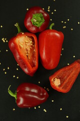 Red peppers on black background