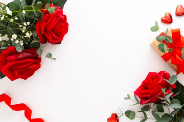 Roses and eucalyptus on white background. Valentine's Day concept, copy space