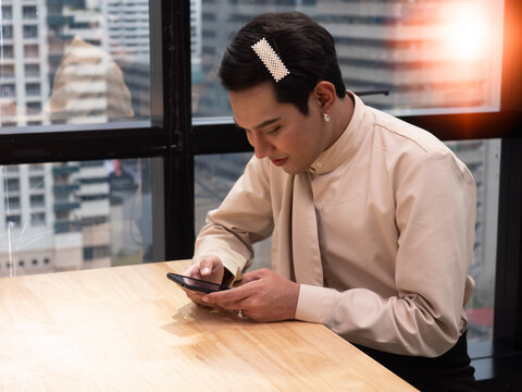 Portrait Of Cute Beautiful Young Man Working In A Model Office. Transgender People And Equality Concept.