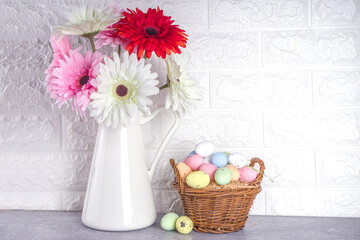 Easter greetings concept. Festive Easter background with spring flowers, painted colorful eggs in a basket.