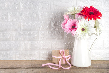Happy mother's day concept. Valentine's day festive background. Women's day, spring day 8 March. Vase with spring flowers and gift box with ribbon bow, copy space