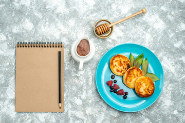 top view delicious muffins with berries on light background taste sugar photo sweet pancake dough