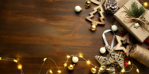 art Christmas banner, Xmas sparkling lights garland with gifts box and wooden tinsel. Christmas greetings cards, headers, website. © Konstiantyn