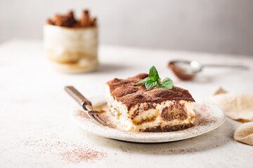 Piece of traditional Italian dessert tiramisu on white background