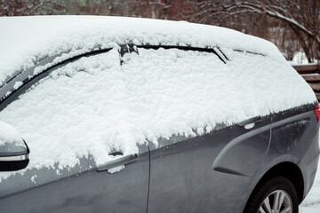 snow-covered car in winter. there are snowdrifts on the roof