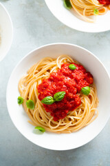 Spaghetti with tomato sauce and basil on a plate