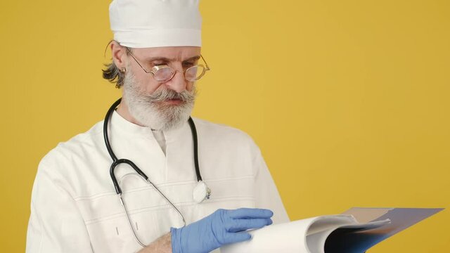 doctor looking at x ray image man doctor corona quarantine xray x-ray virus yellow background medicine old doctor chef cook restaurant pan cooking kitchen jar tasty mask quarintine corona christmas xm