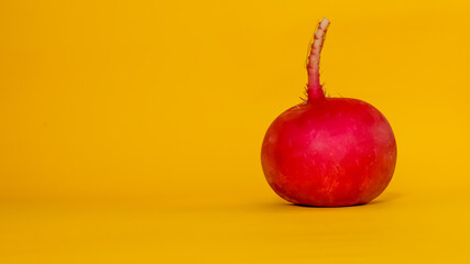 Isolated fresh radish on yellow background. Healthy food.