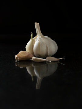 Some pieces of garlic with black background