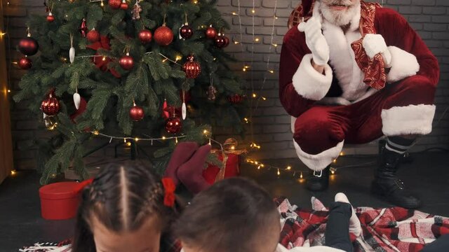 santa with kids christmas tree woman holiday xmas gift santa happy decoration celebration beautiful young red winter child present people beauty smile happiness new year hat box white family new year 
