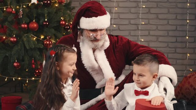 children are happy for the Christmas tree woman holiday gift Santa happy decoration celebration beautiful young red winter child present people beauty smile happiness new year hat box white family