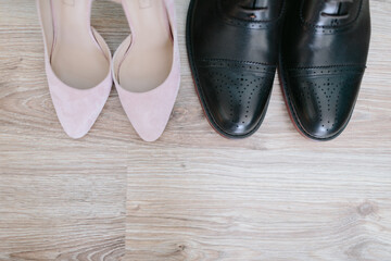 Wedding. The girl in a white dress and a guy in a suit sitting on a wooden chair, and are holding a beautiful bouquet of white, blue, pink flowers and greenery, decorated with silk ribbon