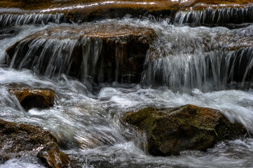 Close up of Creek water flowing over rocks