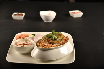 biryani with french omelette served with raita and salad