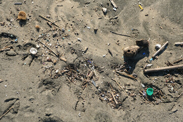 Plastic pollution on sandy sea coast,environmental waste contamination,animal prints