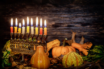 Kwanzaa holiday with decorate candles and pumpkin on wooden background