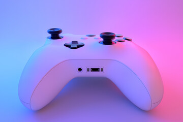 Realistic video game controller in neon lights on white table background © Vasyl Onyskiv