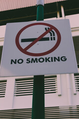 No smoking signage board stick to the pole in public.