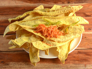 Fafda - Famous snack from gujarat, india. served over a rustic wooden background, selective focus