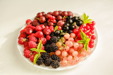Assorted fresh summer berries. Raspberries, gooseberries, blackberries, currants, wild strawberries, strawberries.