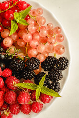 Assorted fresh summer berries. Raspberries, gooseberries, blackberries, currants, wild strawberries, strawberries.