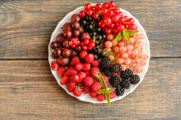 Assorted fresh summer berries. Raspberries, gooseberries, blackberries, currants, wild strawberries, strawberries.