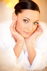 Beautiful girl in a white terry dressing gown in  interior