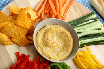 Hummus in a bowl,  vegetarian snack, healthy food with vegetables