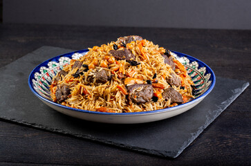 The concept of oriental cuisine. Assorted Uzbek food set, pilaf, samsa, lagman, manta, shurpa...