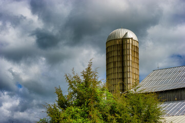 Stormy skies hang over a silo and barnroof in rural Tennessee