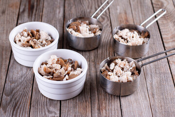 French dish julienne. Mushroom, chicken and cheese gratin in ceramic bowls, on table
