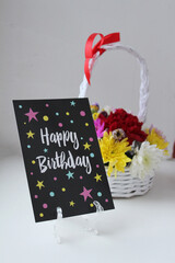Happy Birthday. Postcard, bright flowers in a basket