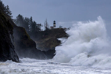Large waves crashing against cliffs at Cape Disappointment on the Washington coast during King Tide - 399819415