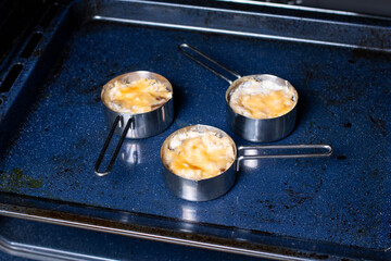 Julienne with mushrooms. Mushrooms are baked in cream and with cheese