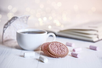 Cocoa, book, white umbrella, cookies and marshmallows.