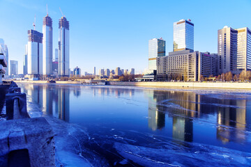 Fototapeta premium Skyscrapers Moscow City International Business Center from the side of the Moskva River with a reflection on fresh ice. December 12, 2020