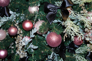 Christmas tree decor close-up in the color scheme green-lilac-black. Horizontal orientation