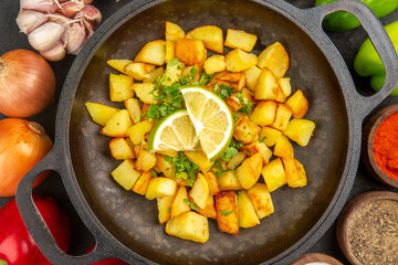 top view fried potatoes inside pan with different seasonings and vegetables on a dark background cuisine meal food color pepper